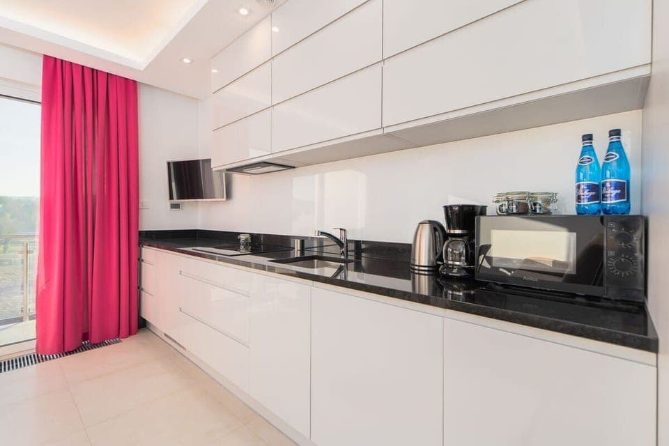 Bright kitchen with cooking utensils. 