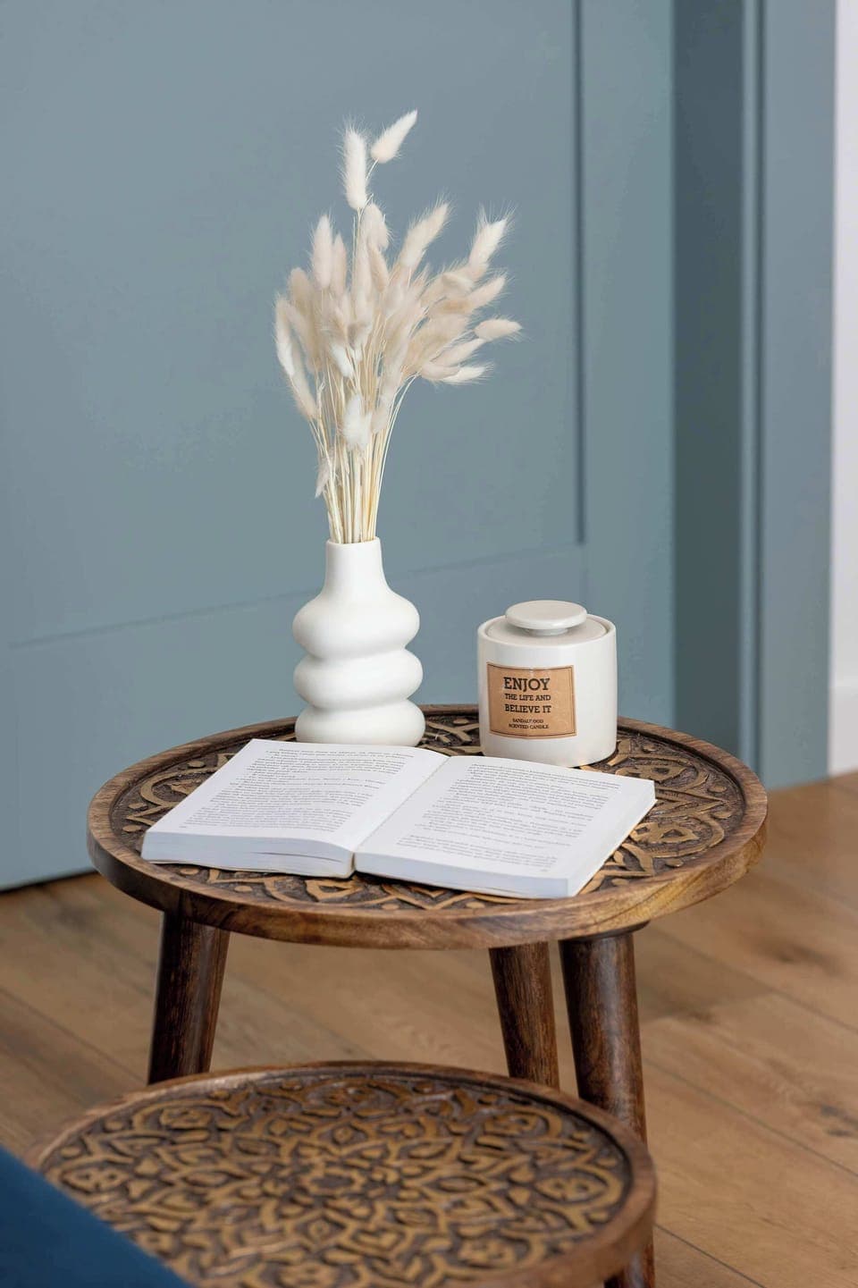 A close-up of the wooden tables shows that the apartment has no shortage of pedestrian accessories to pass the time.