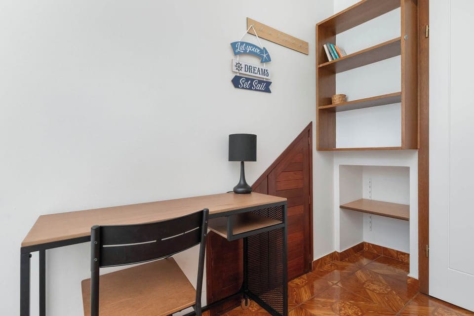 A practical workspace with a desk and chair, placed by the window for natural light – ideal for studying or remote work.