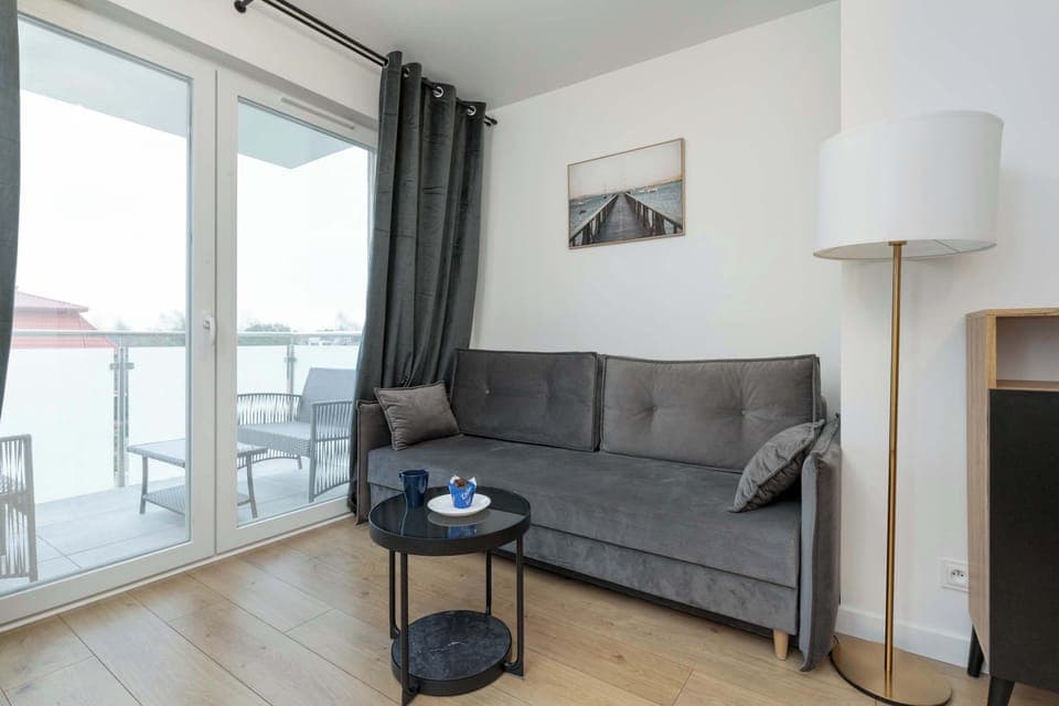 Relax in the stylish living room with a comfortable sofa and modern decor.