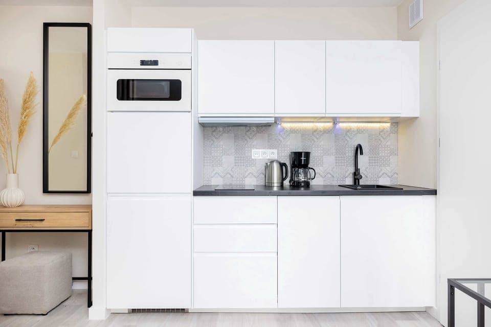 The sleek design of the kitchenette blending seamlessly with the living area.