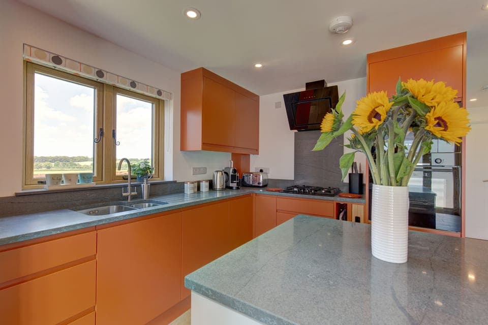 Fantail, Harpley: A cheerful kitchen with a lovely view