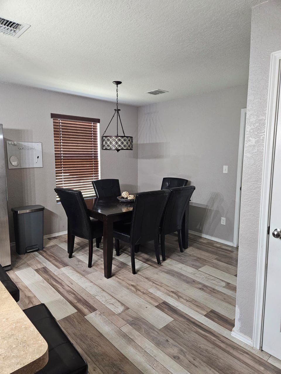 The dining area, next to the kitchen, seats 9 guests including bar stools.