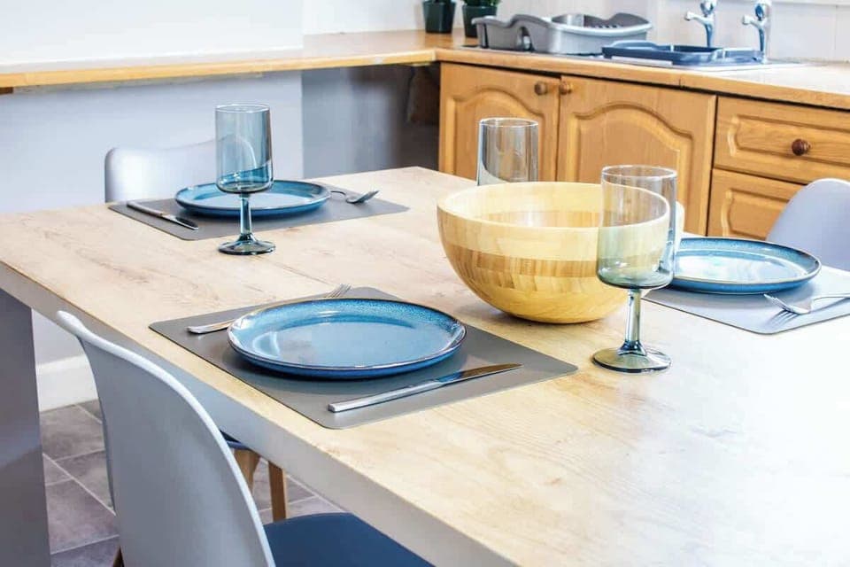 An elegant dining area with a stylish table, comfortable chairs, and ambient lighting, perfect for meals and gatherings.