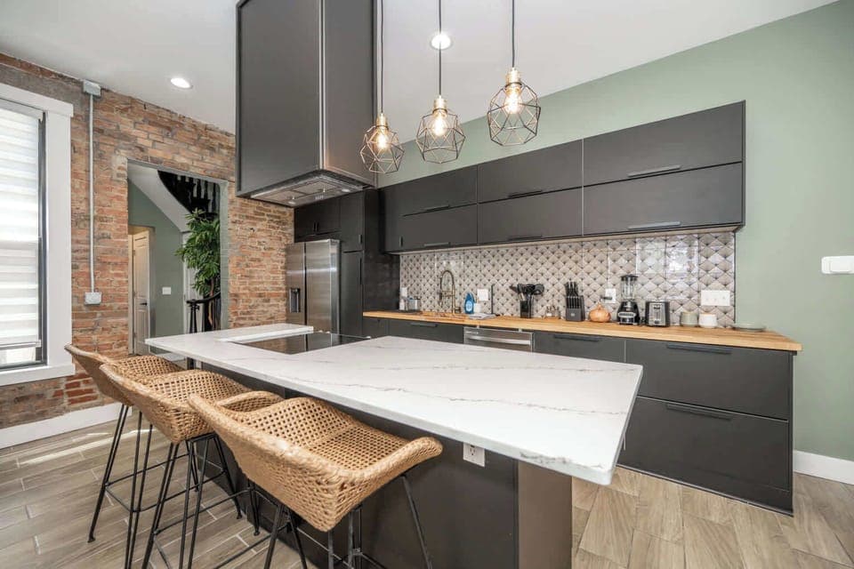 The sleek, modern kitchen offers ample space & every home comfort​
