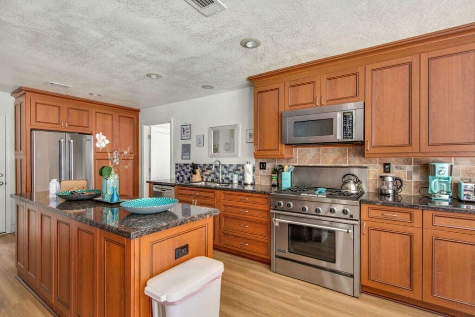 Fully stocked kitchen with stainless appliances.