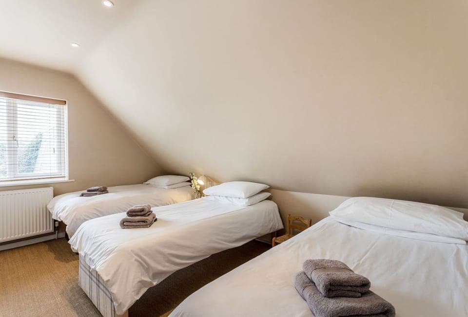 Surfside, Mawgan Porth. First floor: A twin bedroom that's fresh and airy, offering a relaxed atmosphere and a beautiful view of the coastline to wake up to.