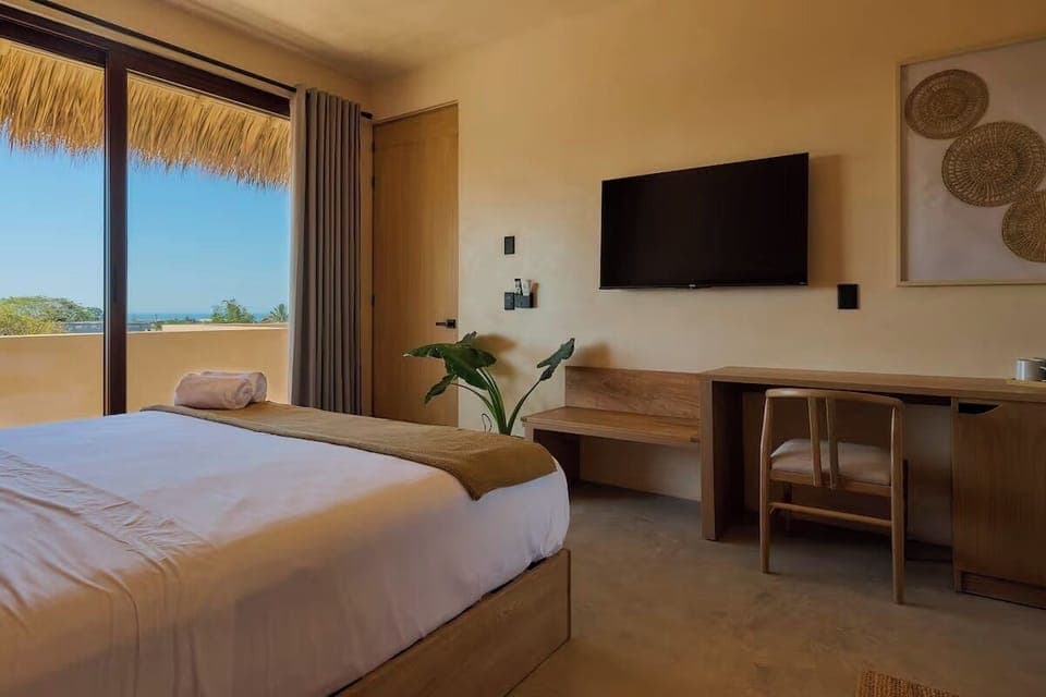 Suite, Balcony, Pool View | Minibar, in-room safe, desk, laptop workspace