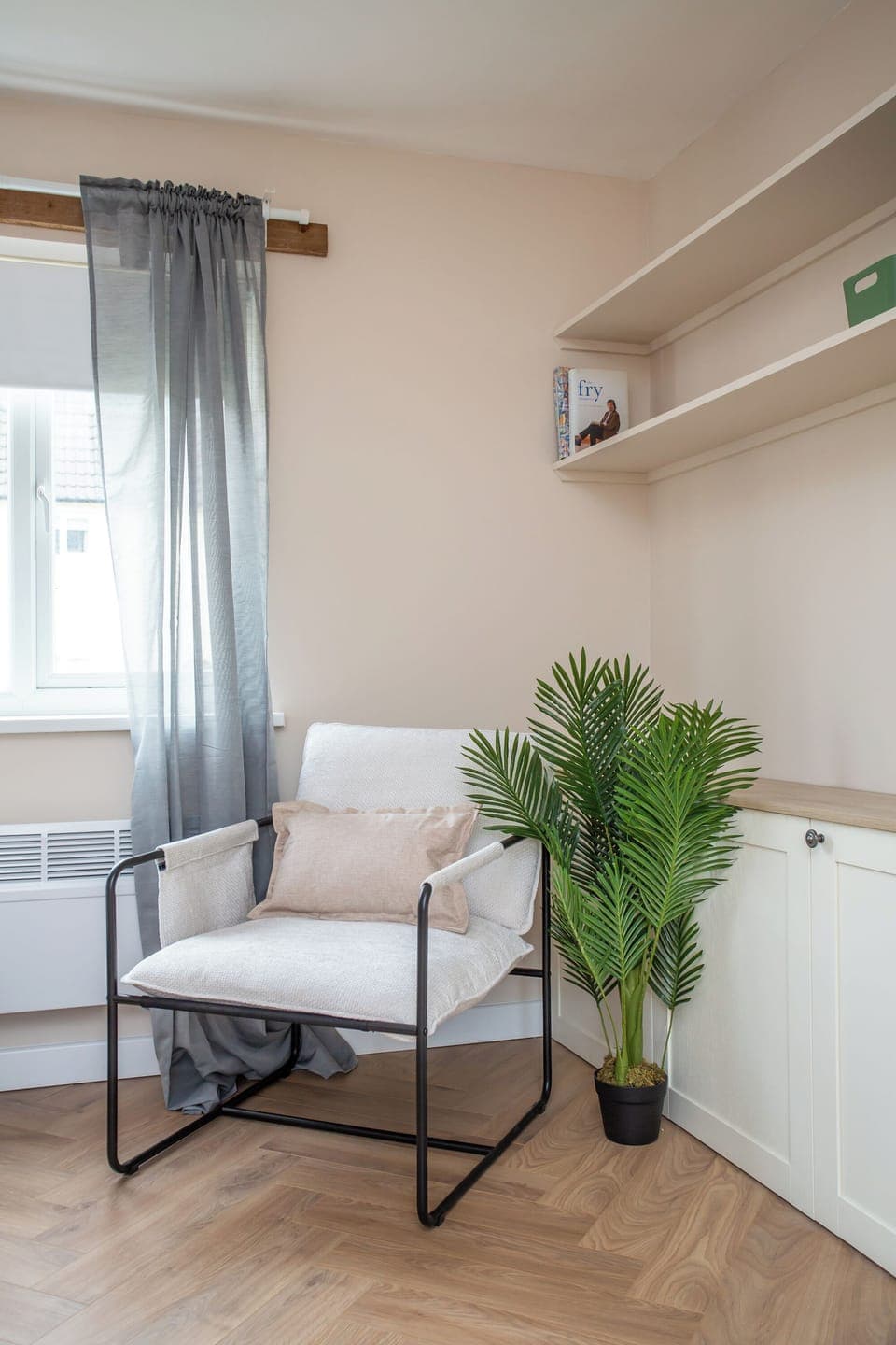 A peaceful reading nook with a soft armchair and natural light streaming through the window
