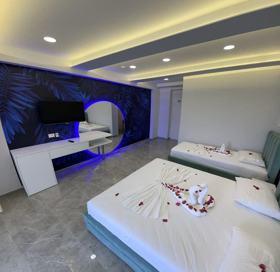 Deluxe Quadruple Room, Balcony, Sea View | Premium bedding, minibar, in-room safe, desk