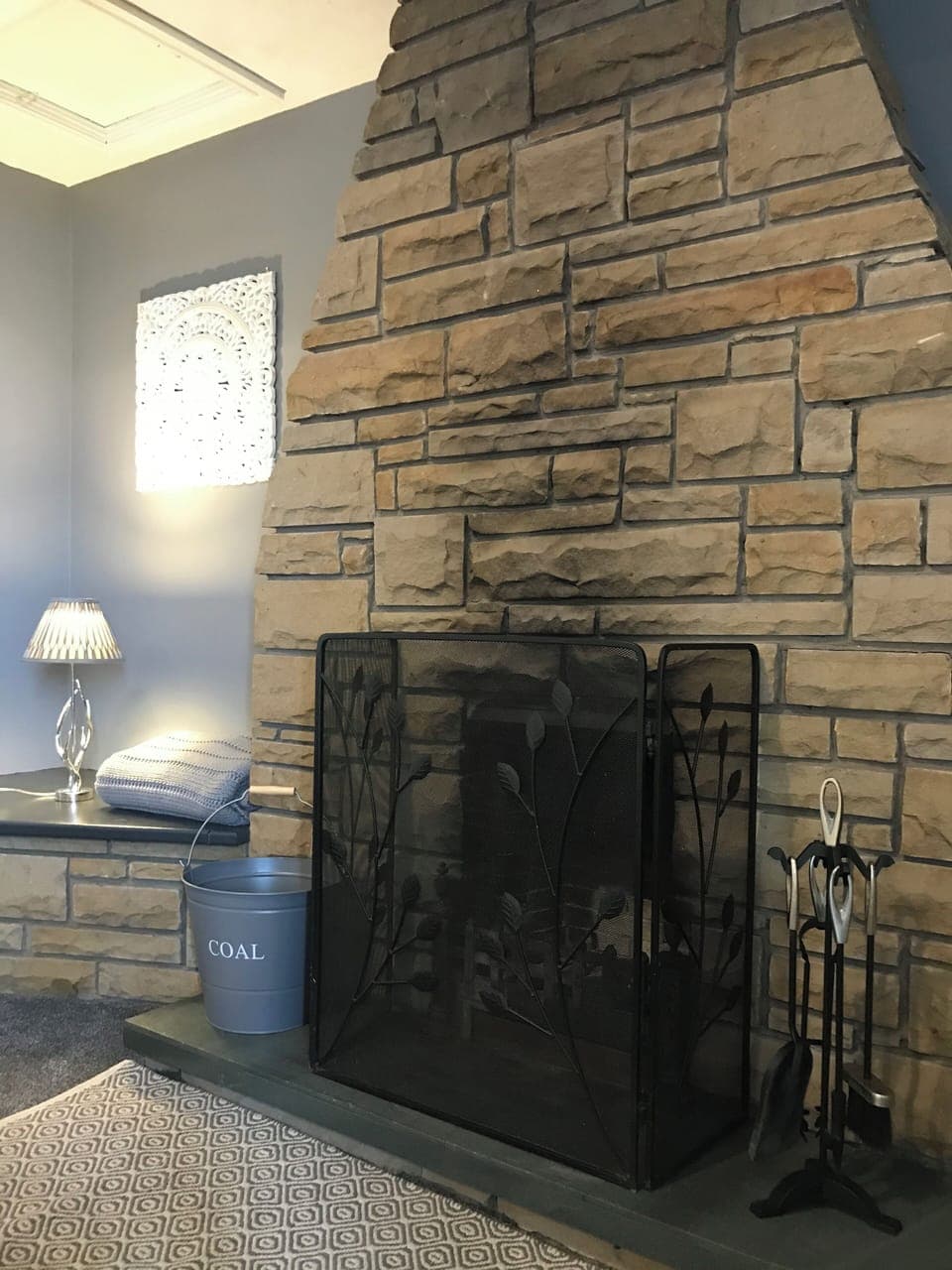 Traditional open fireplace, perfect for creating cozy evening.