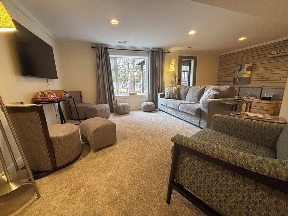 Cozy garden-level living room with TV and comfortable seating