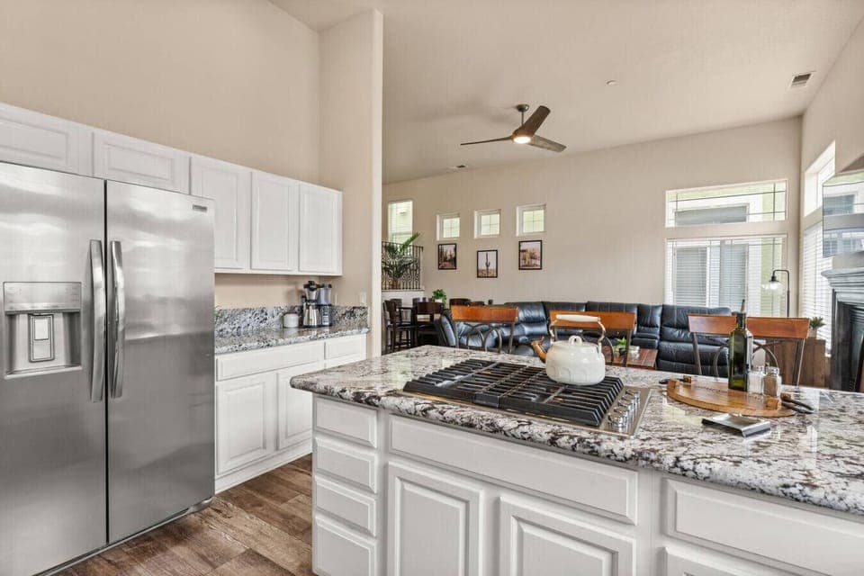 Modern kitchen with granite countertops, stainless steel appliances, and open flow into the living space—perfect for cooking, entertaining, and staying connected while you unwind.
