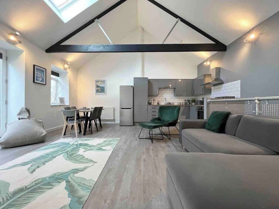 Open plan living room with kitchen and dining table.