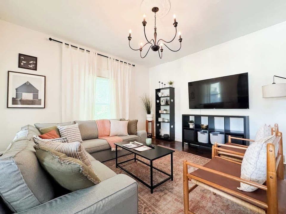 Large sectional couch and a 65" TV in the living room. 