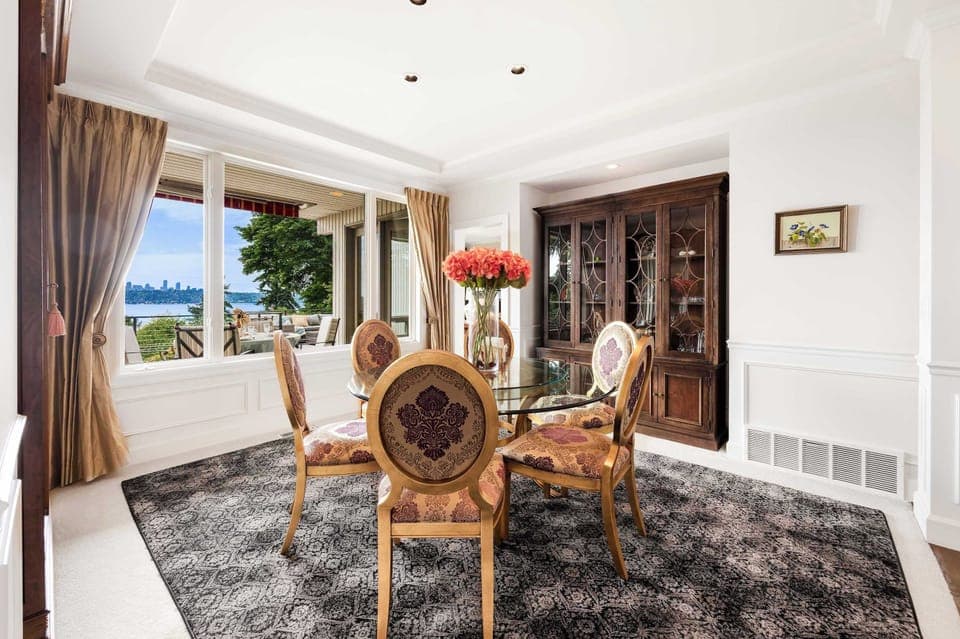 Brunch-ready nook - sunlight streams through arched windows onto your floral centerpiece, with display cabinets for curated collections.