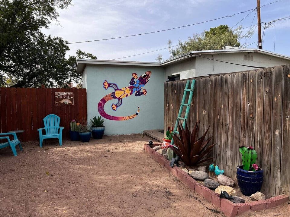 Front Yard - Custom Painted Talavera Inspired Lizard, Dirt Yard, Outdoor Seating, and Fully Fenced