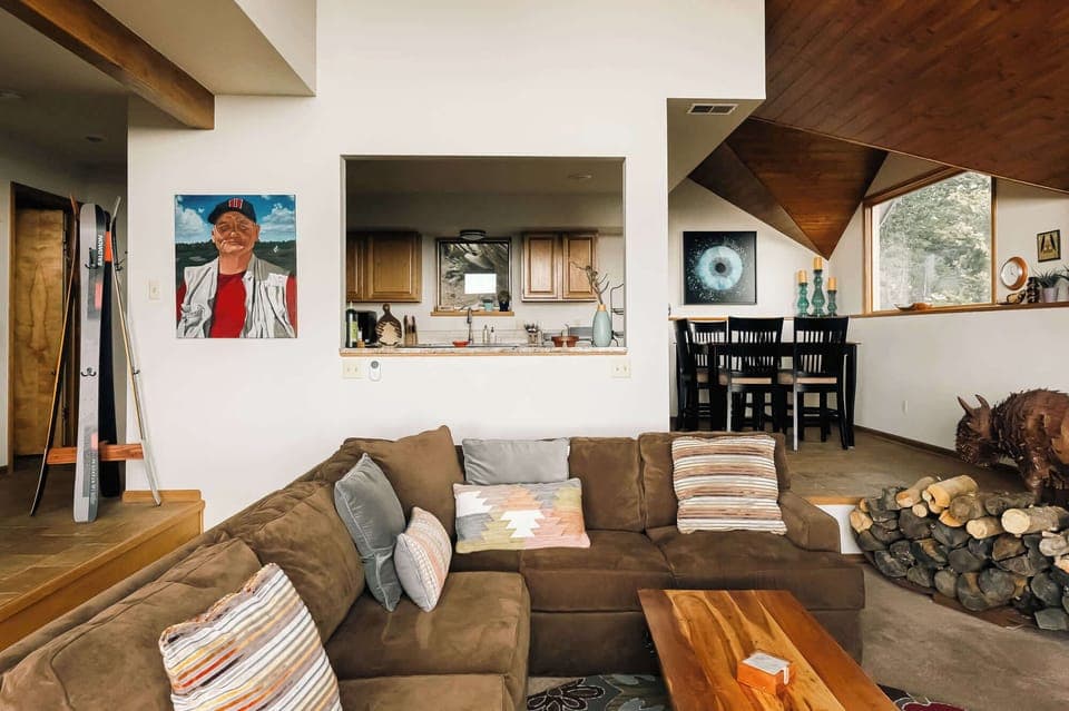 Main level with living area, kitchen, and dining table
