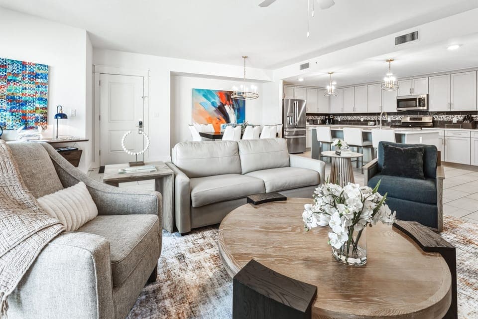 Relax in your stylish open-concept living space featuring plush seating, modern kitchen with sleek appliances, and thoughtful design touches throughout.