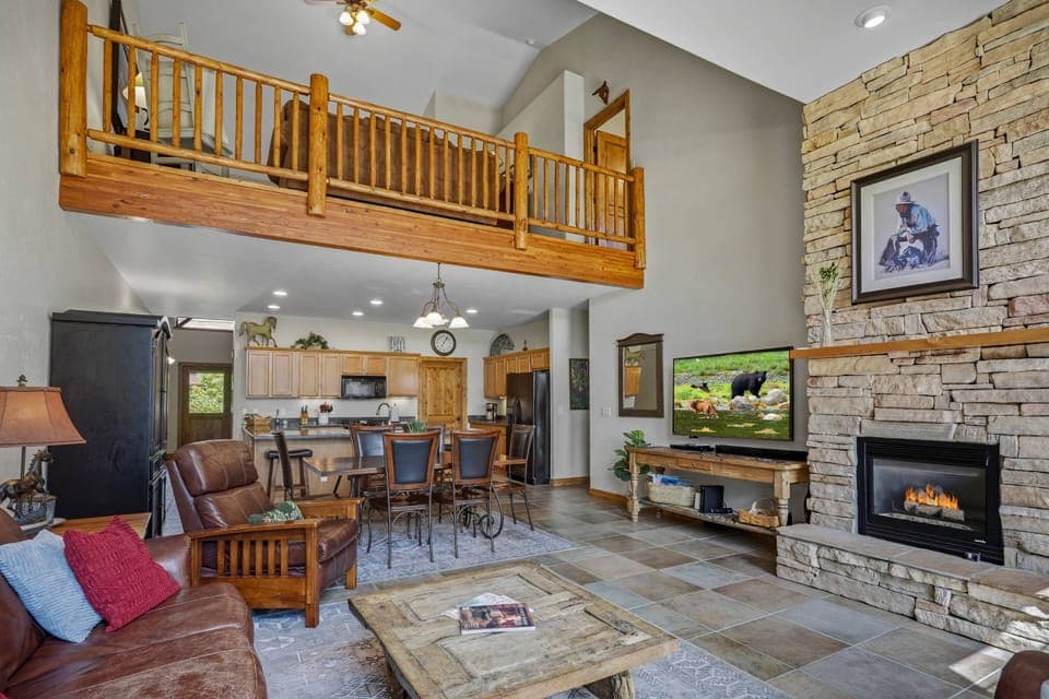 Beautiful view of the loft and wide open main floor. Cozy up to the gas fireplace or curl up for some tv. Uptown convenience and charm awaits!