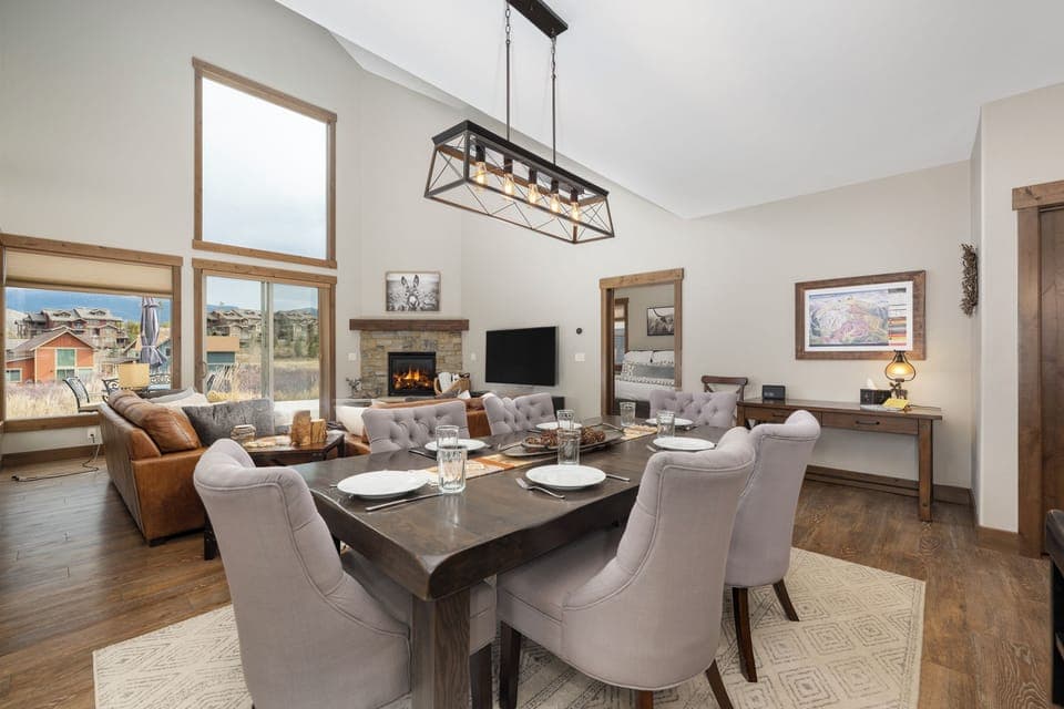 Gather around your elegant dining table while the fireplace crackles nearby, creating perfect moments for memorable meals together.