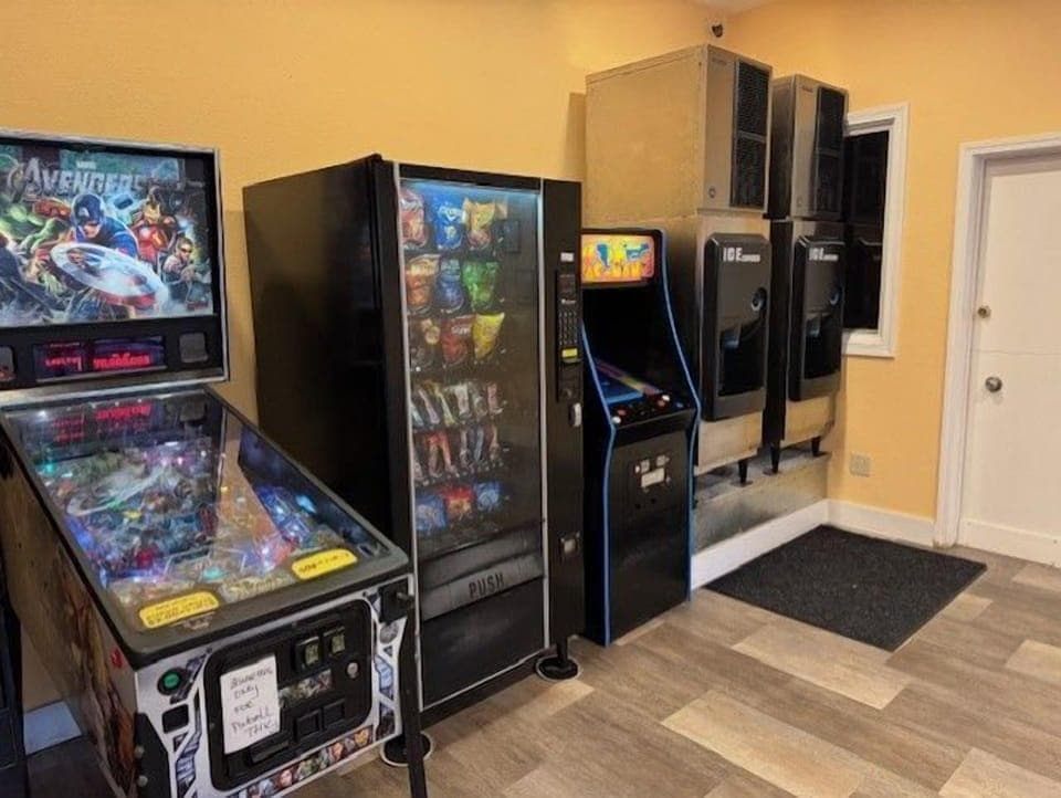 Enjoy a variety of snacks and arcade games in the lively game room, featuring vending machines and classic pinball.