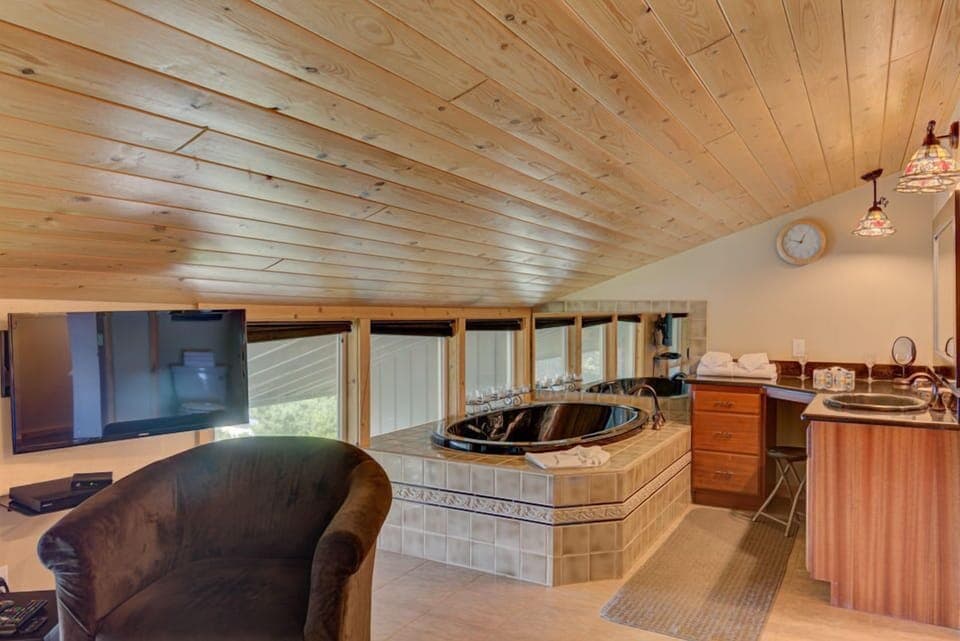 In the king bedroom, enjoy luxury and relaxation with a private jacuzzi tub, all set against a backdrop of stunning ocean views.