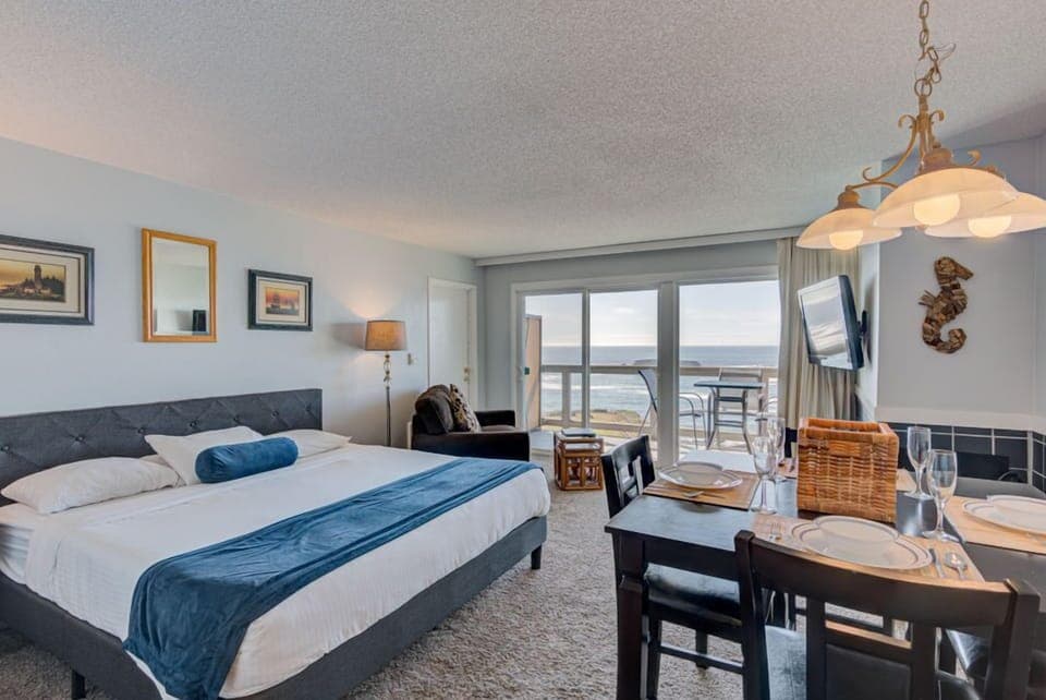 Experience breathtaking panoramic ocean views from this spacious studio featuring a luxurious king bed, a cozy kitchen, and a private patio for ultimate relaxation.