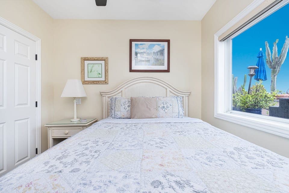 Wake to natural light and views toward the oceanfront deck in this guest bedroom
                