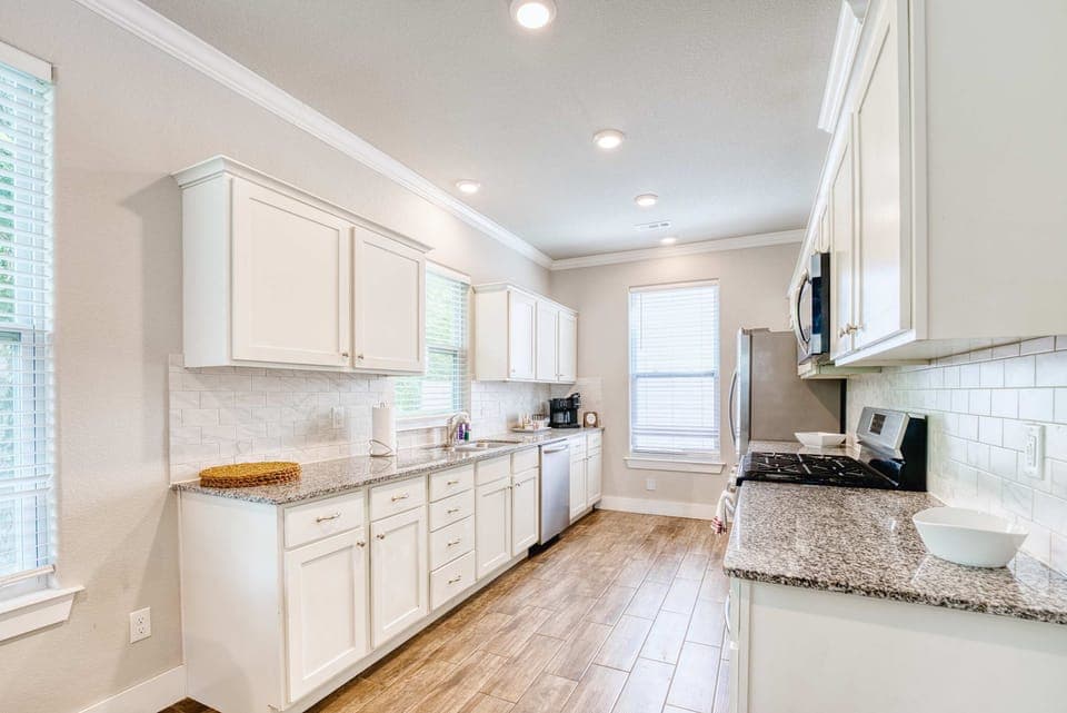 Chef’s kitchen with stainless appliances, granite counters, and a coffee bar stocked for morning brews.