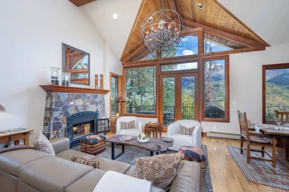 Living room (main floor): Gas fireplace, 65” Samsung Smart TV, access to deck with grill