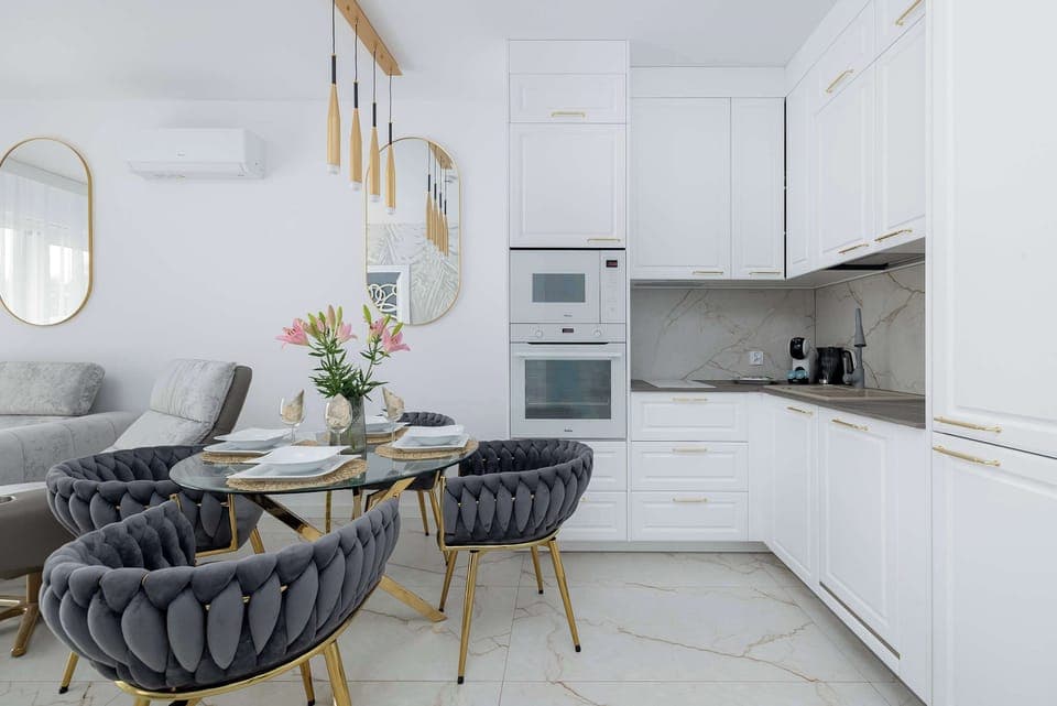 A compact kitchen with white cabinetry and modern appliances. The space is practical and designed for everyday cooking.