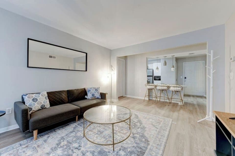 Bright open living area w/ comfy seating & plenty of natural light.