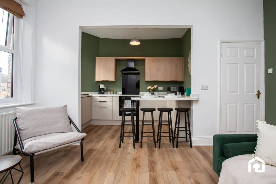 Fully equipped kitchen featuring sleek cabinetry, a cooktop, and all essentials for a comfortable stay