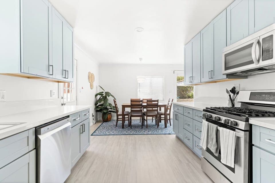 Bright, modern kitchen with stylish blue cabinets and a cozy dining area