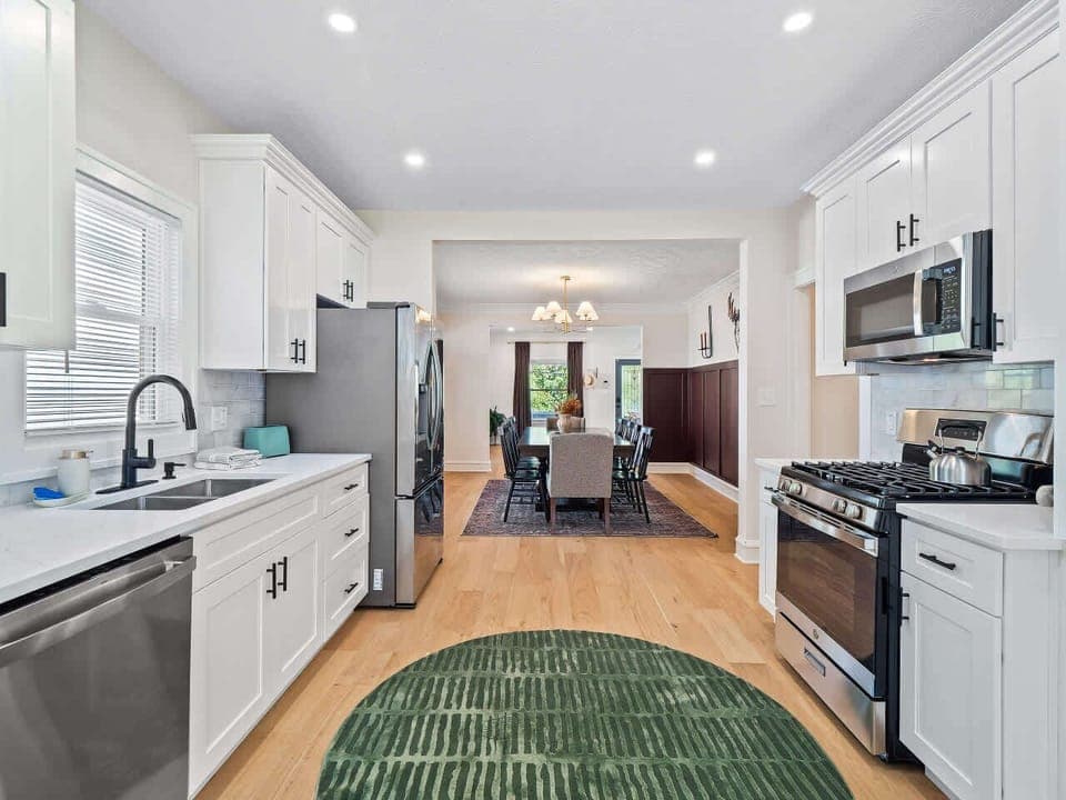 Open kitchen seamlessly connected to the dining area, featuring updated appliances, ample storage, and everything needed for home-cooked meals.