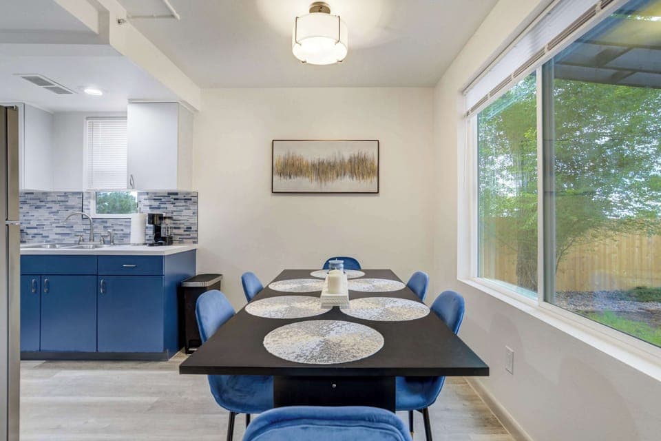 Open-concept design connecting the dining area, modern kitchen, and cozy living room, ideal for gathering with family and friends.