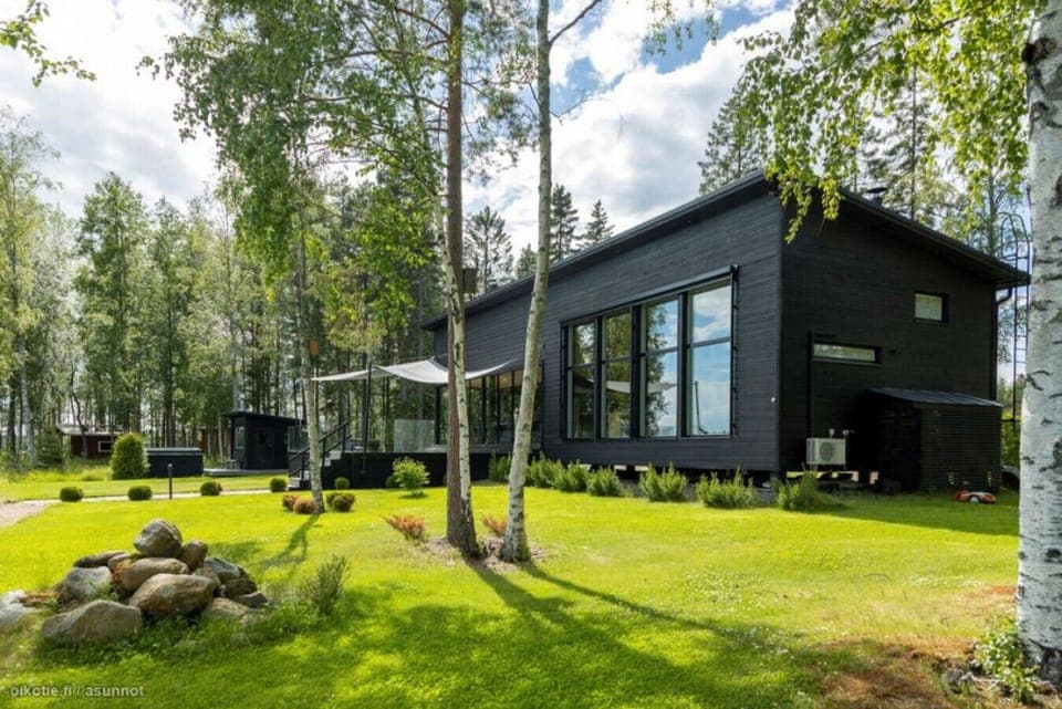 Spacious garden with a modern villa set in beautiful natural surroundings.