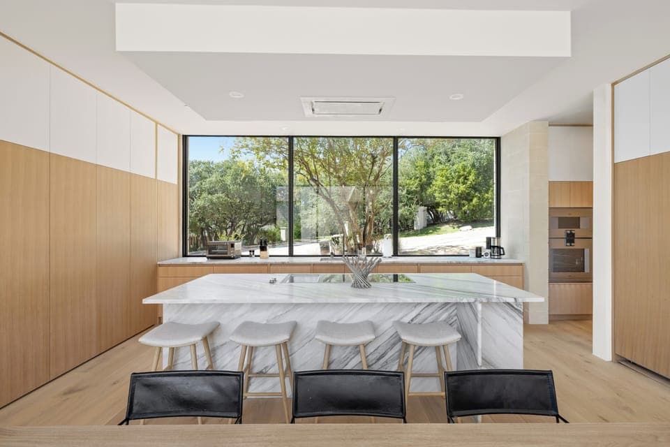 Bright and open concept kitchen with bar seating for four people