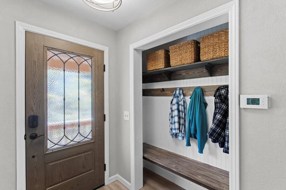 Entryway with coat hooks and storage.
