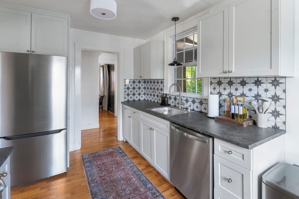 Fully stocked kitchen with cooking oils, spices, paper towels, dishsoap and dishwasher
