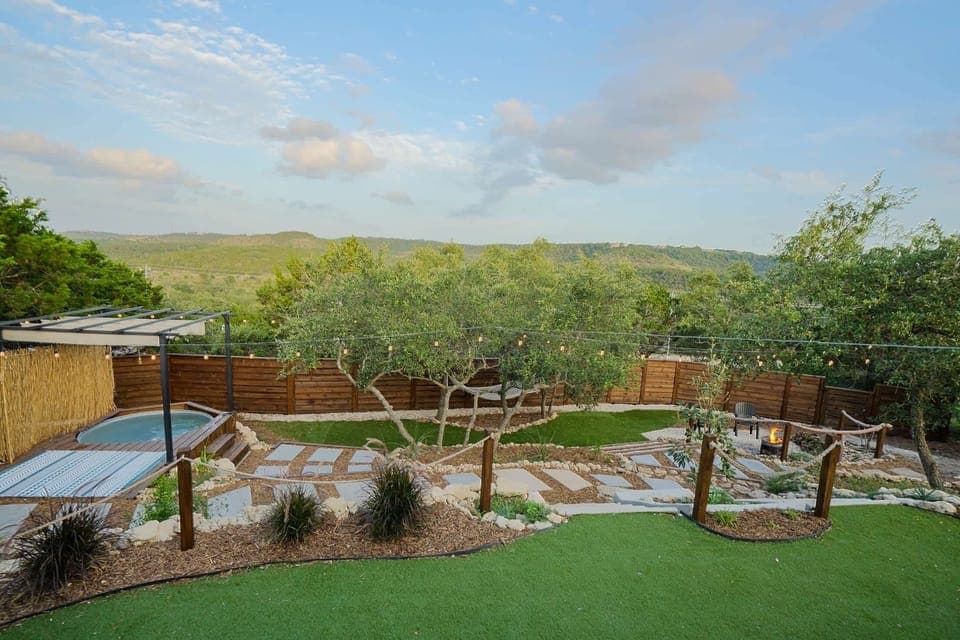 Relaxed and welcoming, the backyard features a cowboy pool, string lights, and landscaped touches—all set against the backdrop of Canyon Lake.