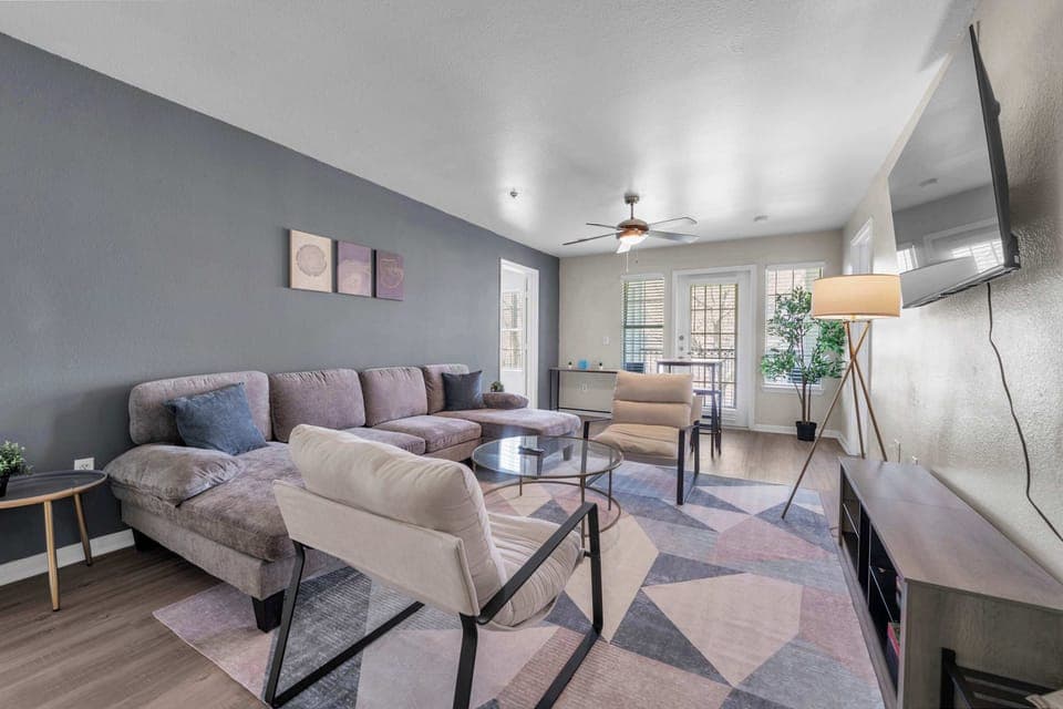 Bright living room w/ cozy sectional seating & open layout for easy gathering.