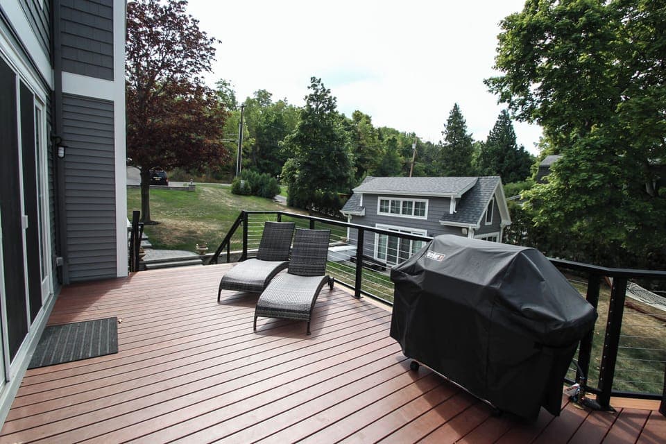 Lounge in comfort or fire up the grill on this stylish deck with cozy seating and peaceful views.