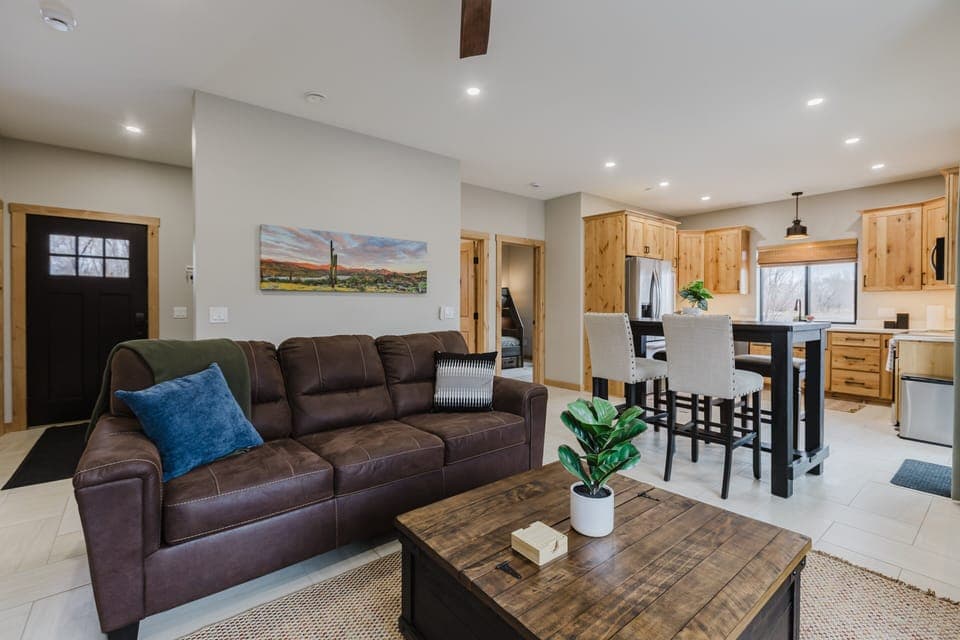 The living room invites you to relax with a plush sofa and a large smart TV