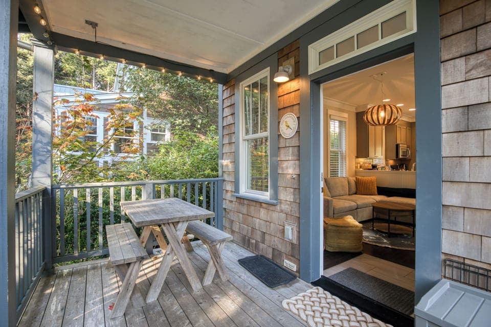 Covered patio with picnic table for outdoor dining. 