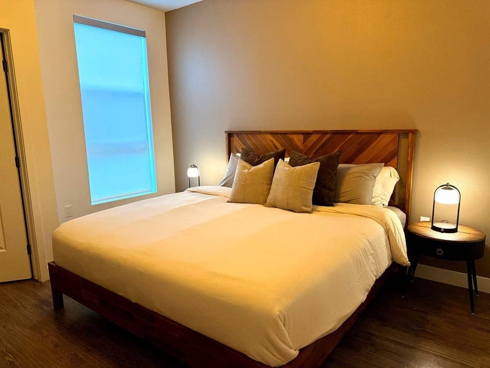 Indulge in ultimate comfort with a plush memory foam king-size bed, elegantly dressed in soft cotton sheets and smooth pillowcases.