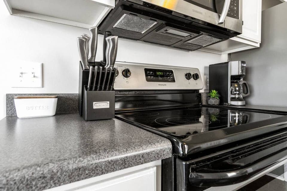 The stove, oven, and microwave are paired with a full knife set and coffee maker—everything you need for a seamless cooking experience.