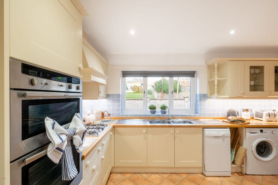 Ground floor: Kitchen with built-in oven, dishwasher, toaster, kettle, and washing machine