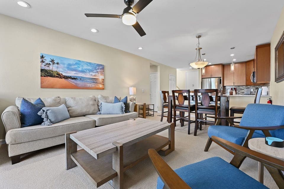 Plenty of seating for everyone, including a large, comfortable sofa, two modern chairs, and a cozy recliner